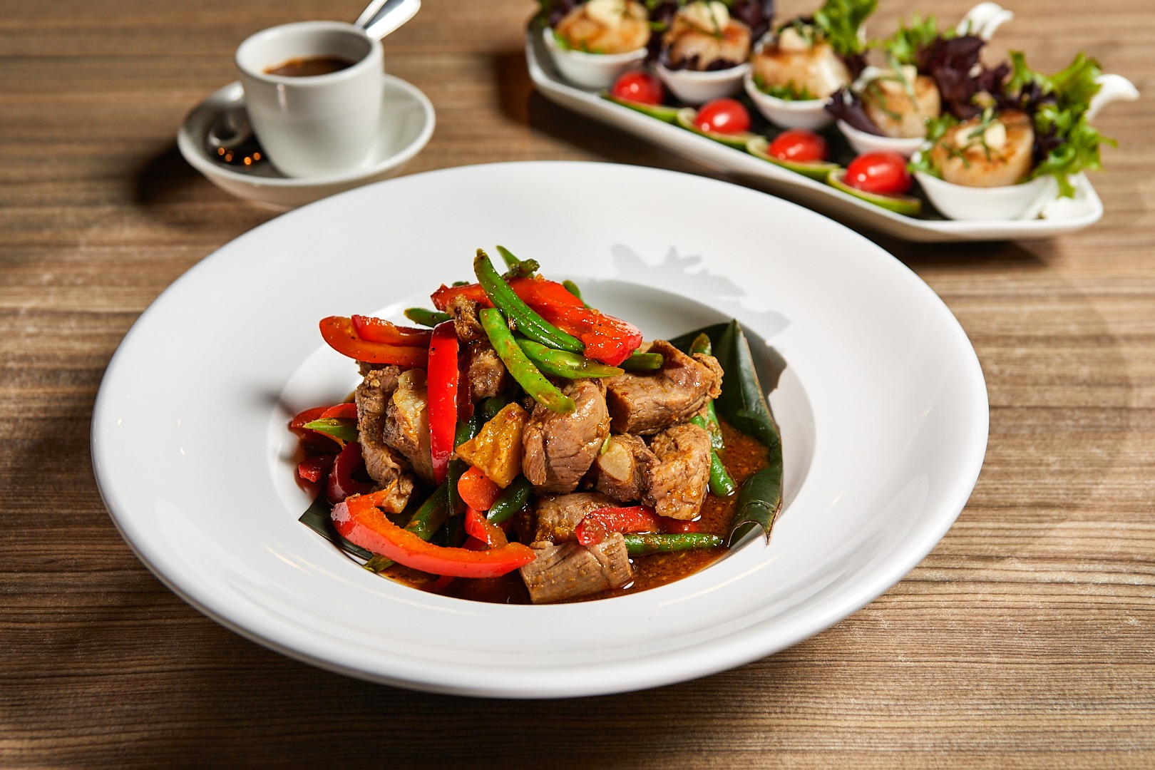 A colorful Thai stir-fry with peppers and fresh vegetables at Manaao